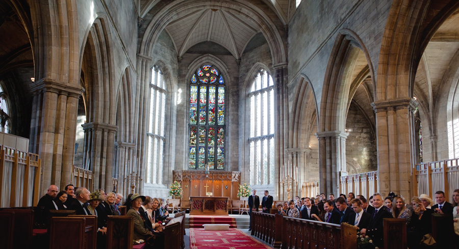 Groom awaiting his bride at St. Michaels' Parish in Linlithgow