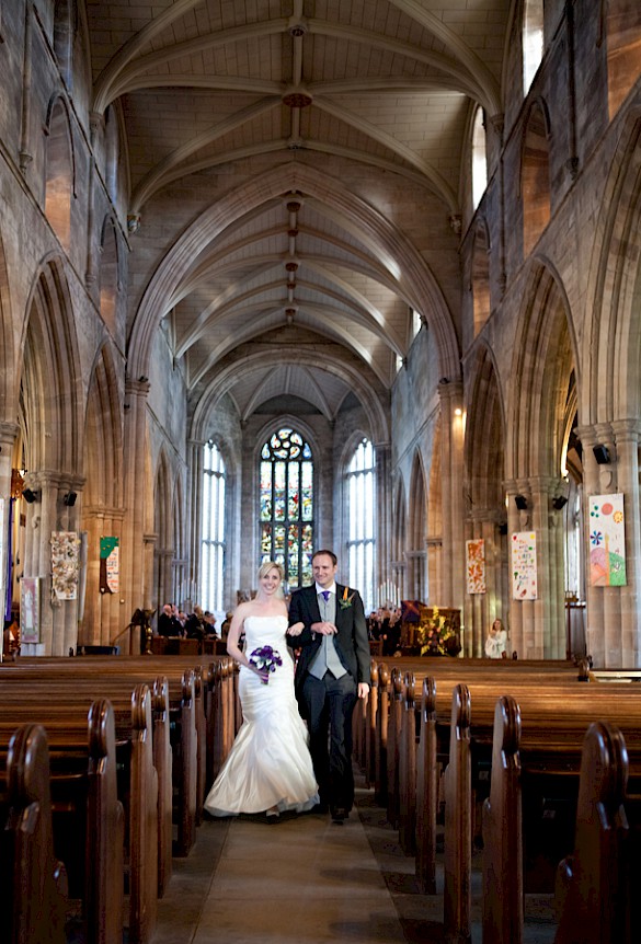 Bride and groom leaving the wedding ceremony at St. Michaels' Parish in Linlithgow
