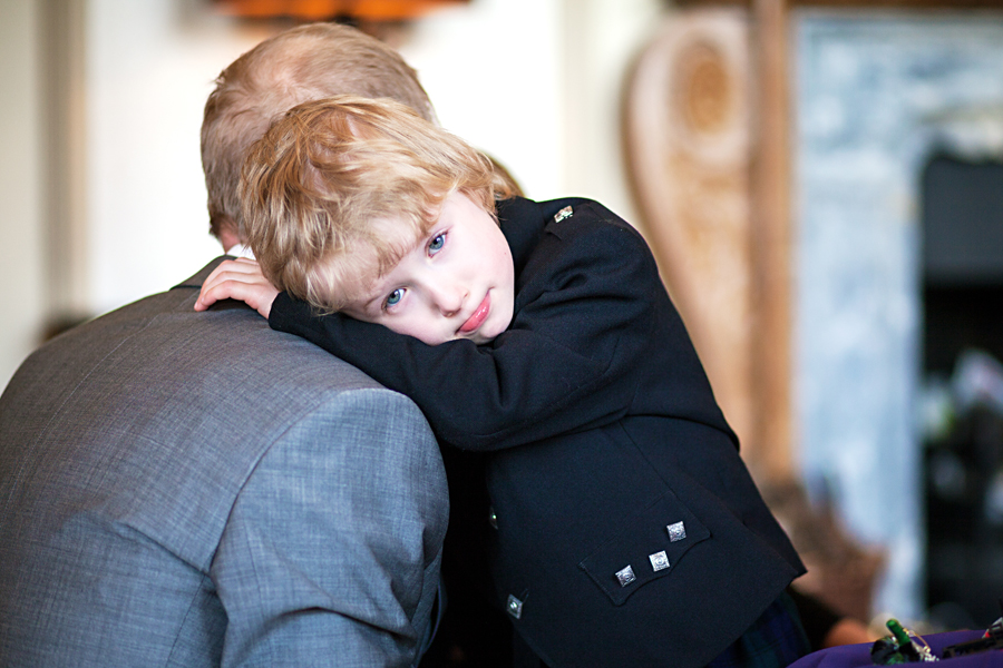 Groom getting a hug from his little son before the wedding ceremony at Cringletie House