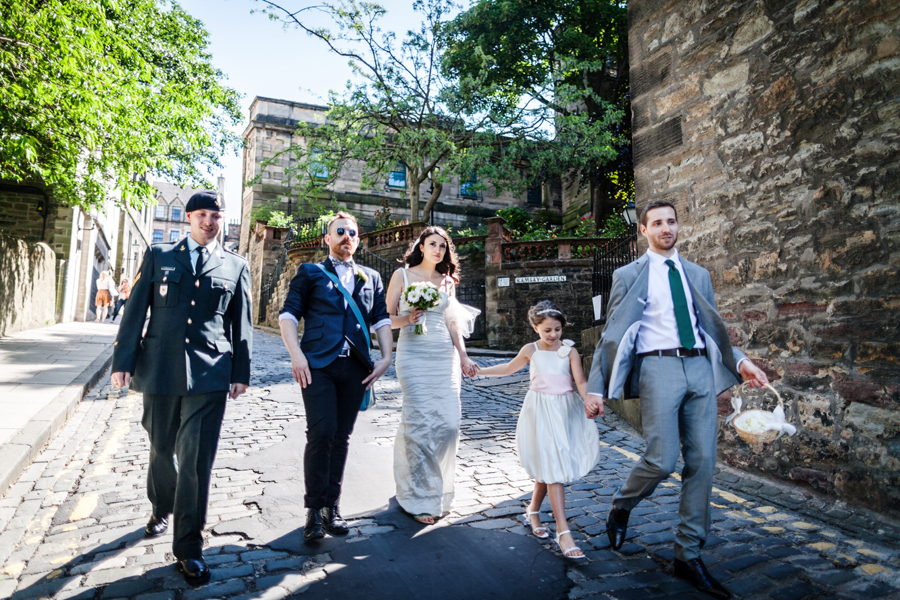 Bridal party walking in the city centre of Edinburgh near the Royal Mile