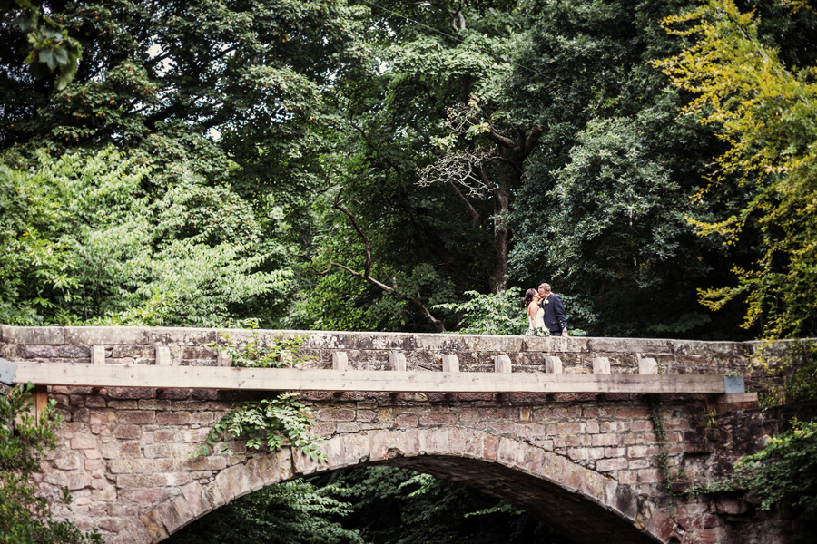 Bride and groom kissing on the bridge at Dalhousie Castle in Bonnyrig