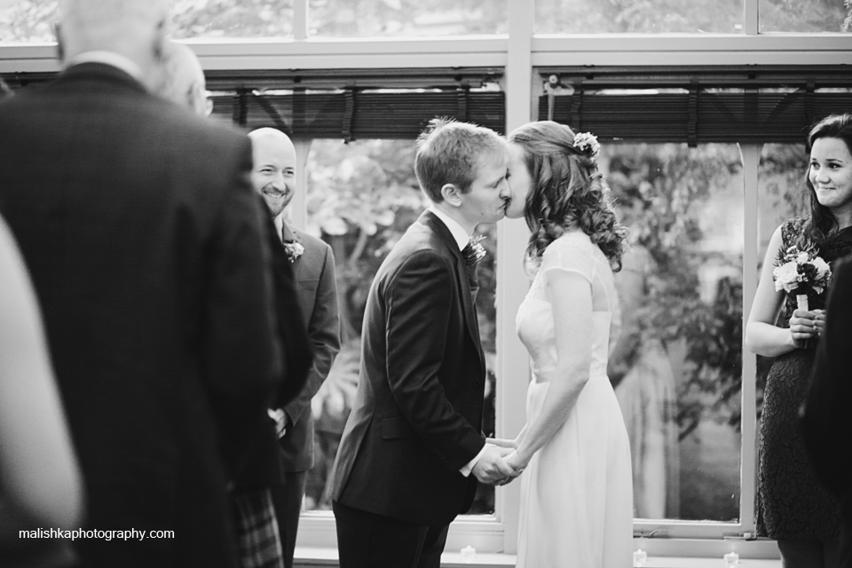 Bride and groom kiss at the wedding ceremony