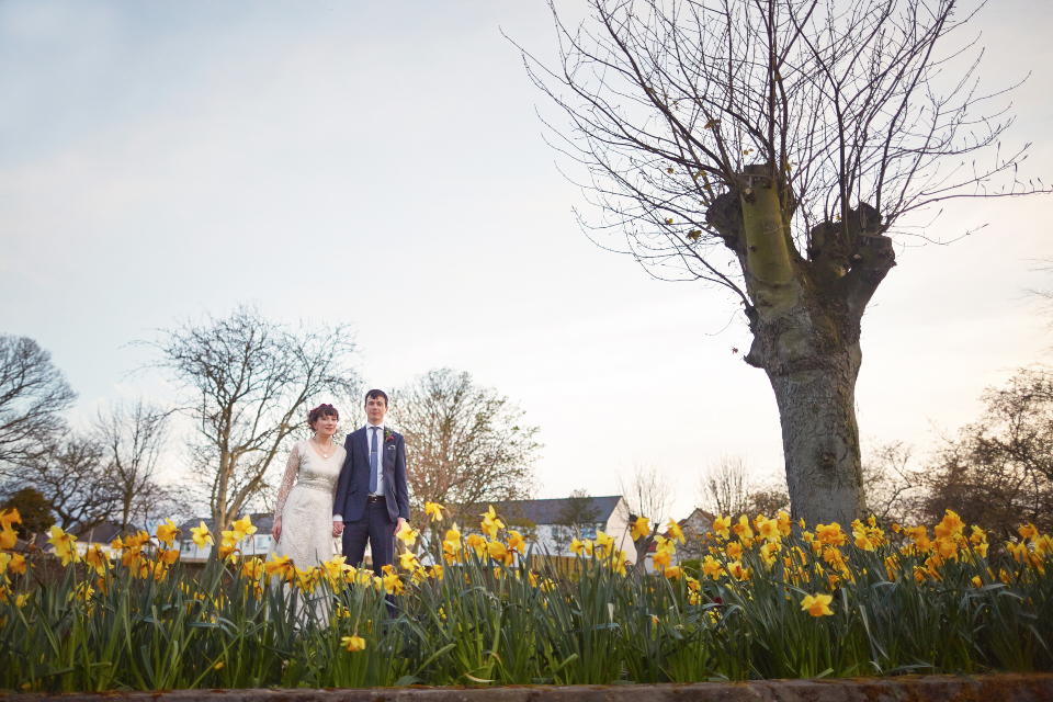 Bride and groom among daffodils in Scotland, Crail Hall