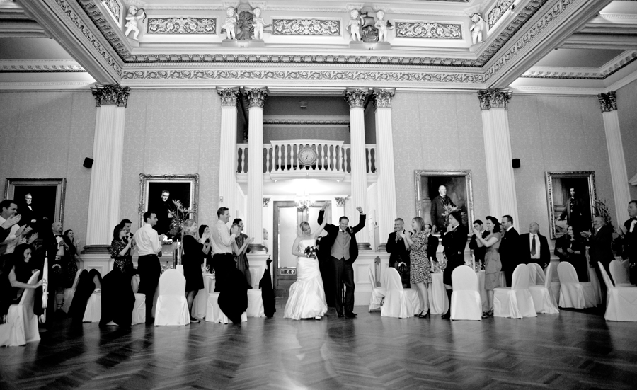 Happy bride and groom entering Merchant's Hall in Edinburgh