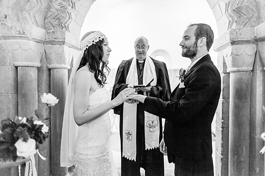 Bride and groom exchanging rings at Edinburgh Castle wedding ceremony