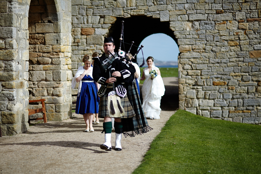 Piper leading the bride at Inchcolm Island wedding