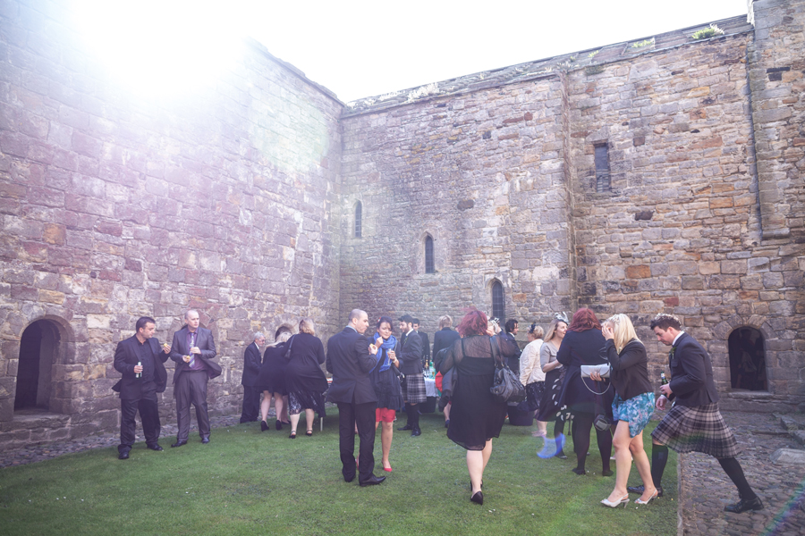 Guests mingling on Inchcolm Island during the wedding drinks