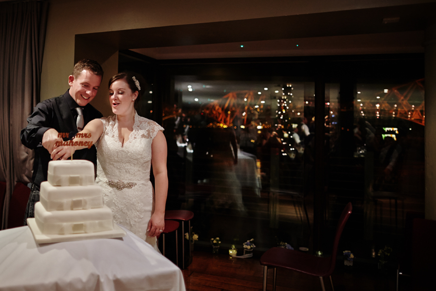 Bride and groom cutting the cake at Orocco Pier in South Queensferry during their wedding