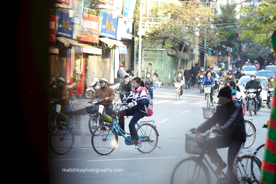 Early morning cyclists on the streets of Hanoi