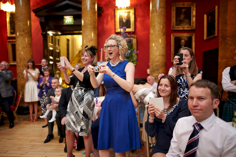 Cheering wedding guests during the first dance at Royal College of Physicians in Edinburgh