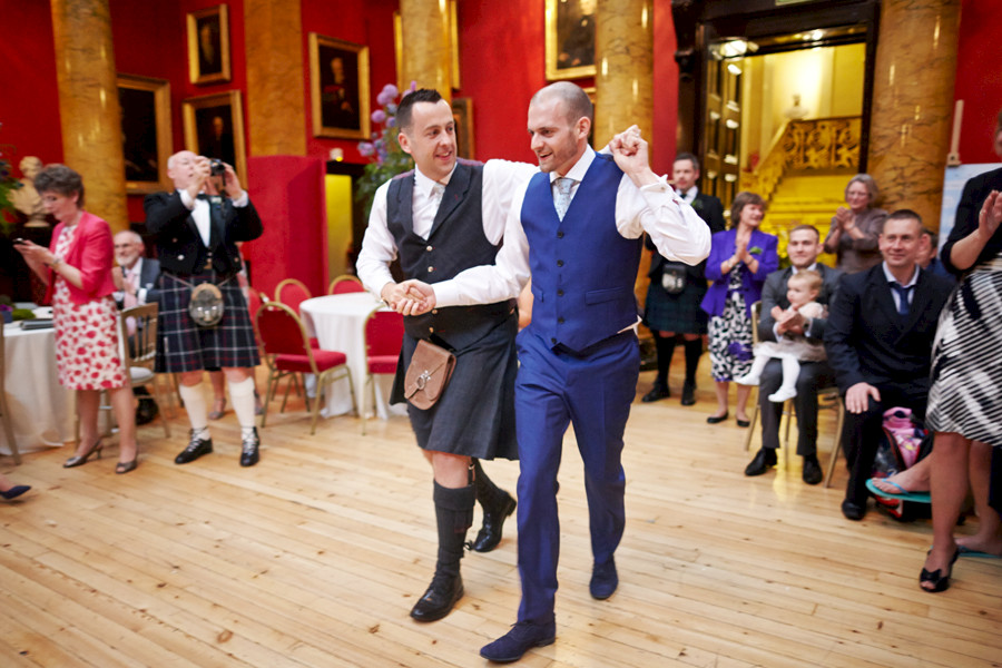 Same-sex couple dancing their first dance at civil partnership at Royal College of Physicians in Edinburgh