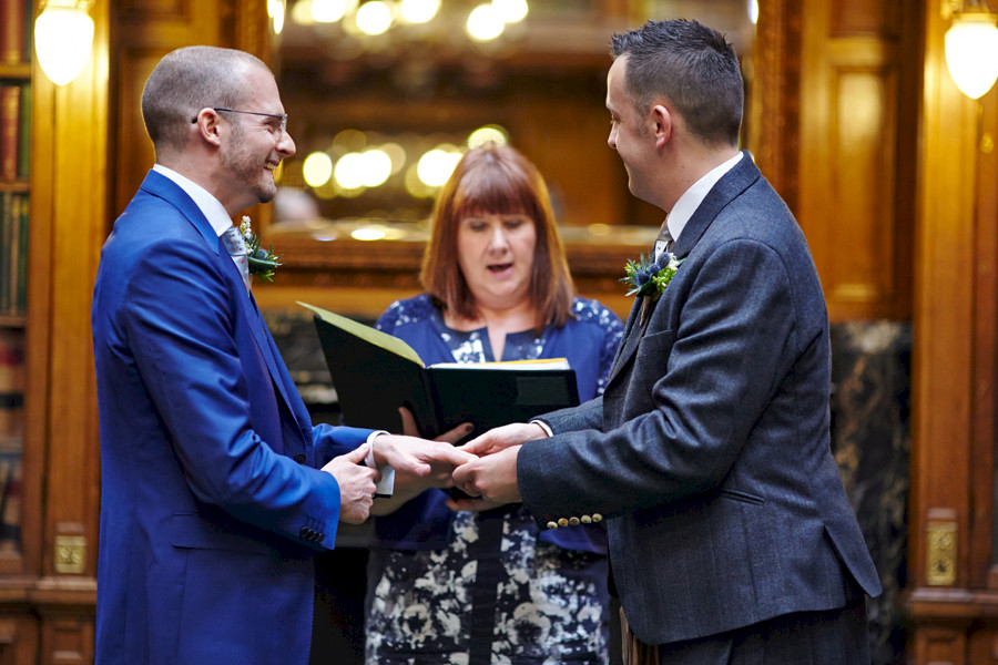 Happy moments during civil partnership ceremony at Royal College of Physicians in Edinburgh