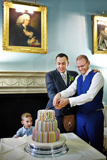 Couple cutting the wedding cake at civil partnership at Royal College of Physicians in Edinburgh