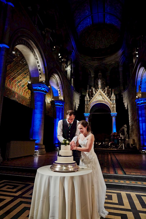 CITY WEDDING IN EDINBURGH  at MANSFIELD TRAQUAIR of the couple cutting the cake
